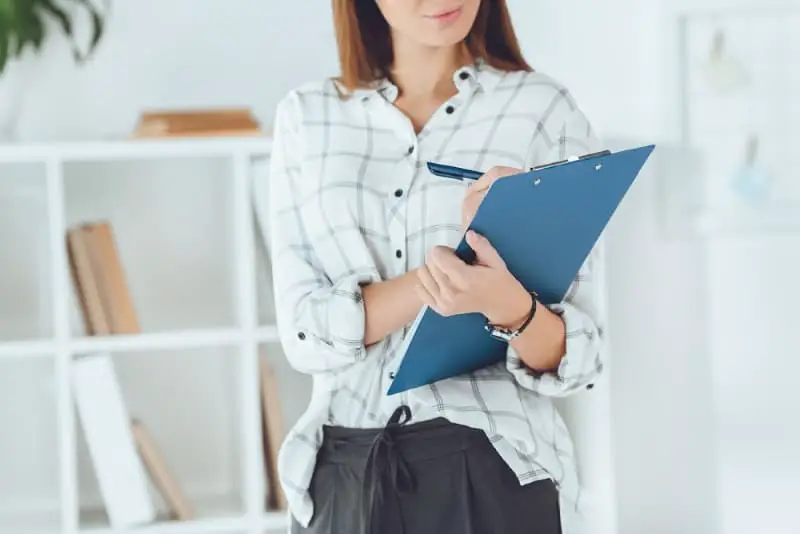 business woman with a clipboard and checklist in an office